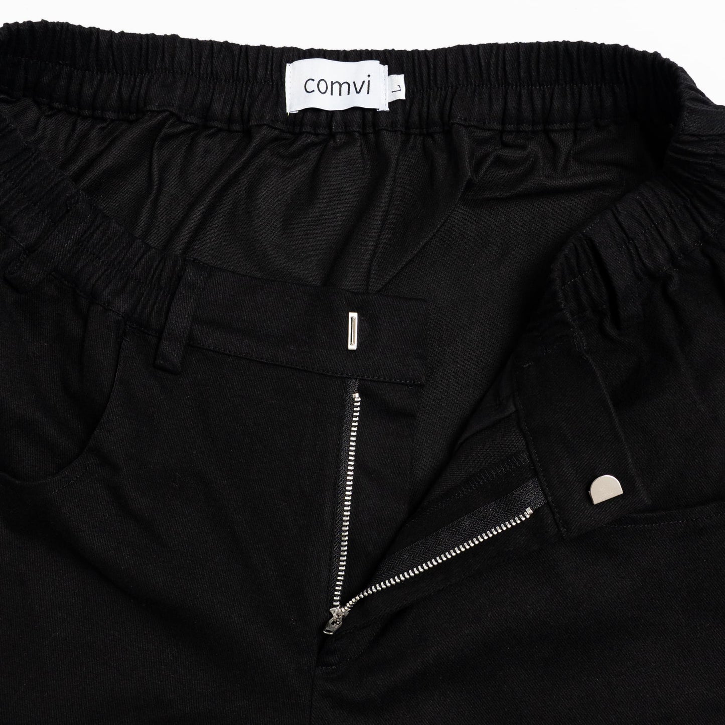“Close-up of pull-up loops disguised as belt loops for easier dressing and adaptive hook-and-loop fly closure.”
