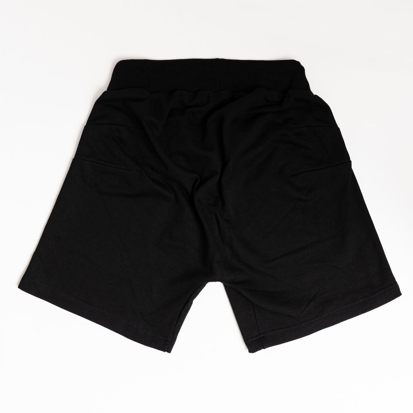 “Back view of adaptive shorts with no seams or pockets, designed to prevent pressure injuries while seated.”