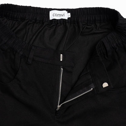 Close-up of pull-up loops disguised as belt loops for easier dressing and adaptive hook-and-loop fly closure. front detail