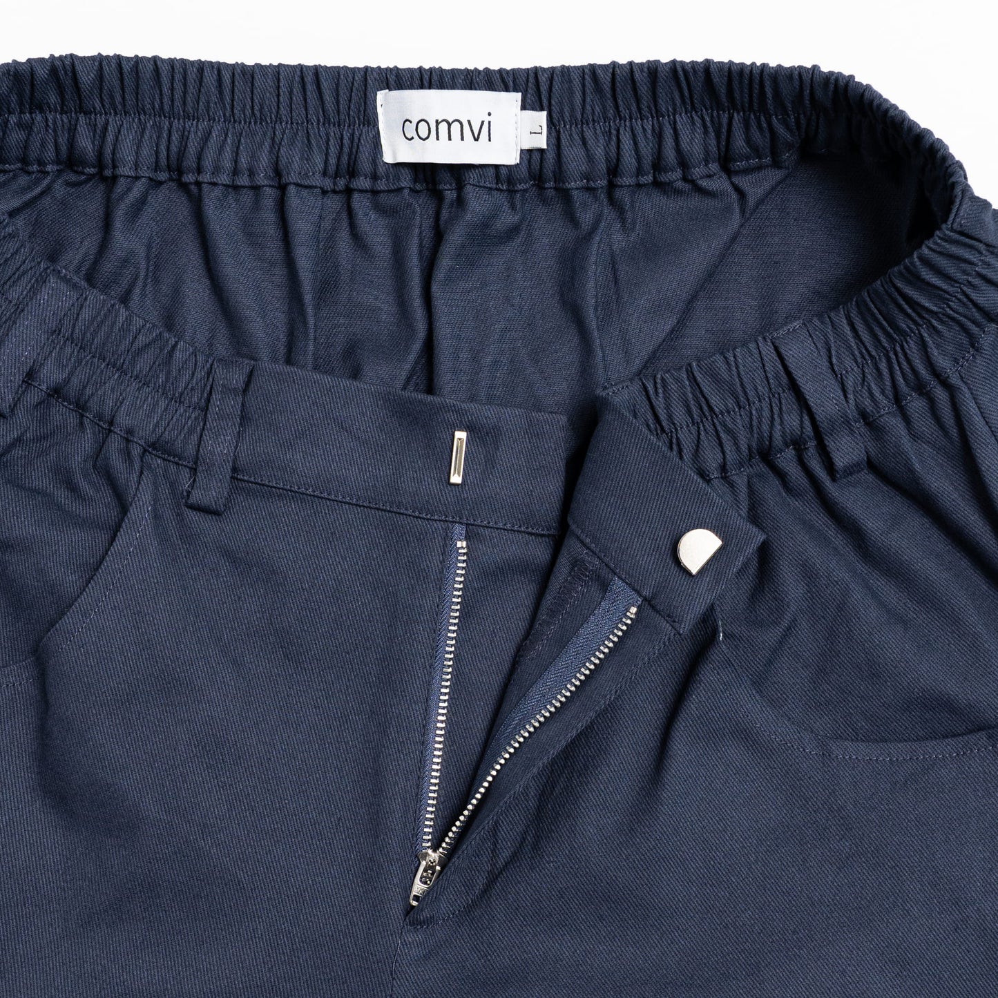 “Close-up of pull-up loops disguised as belt loops for easier dressing and adaptive hook-and-loop fly closure.”