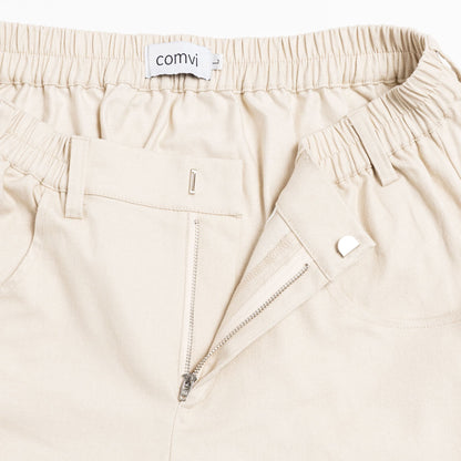 Close-up of pull-up loops disguised as belt loops for easier dressing and adaptive hook-and-loop fly closure.

